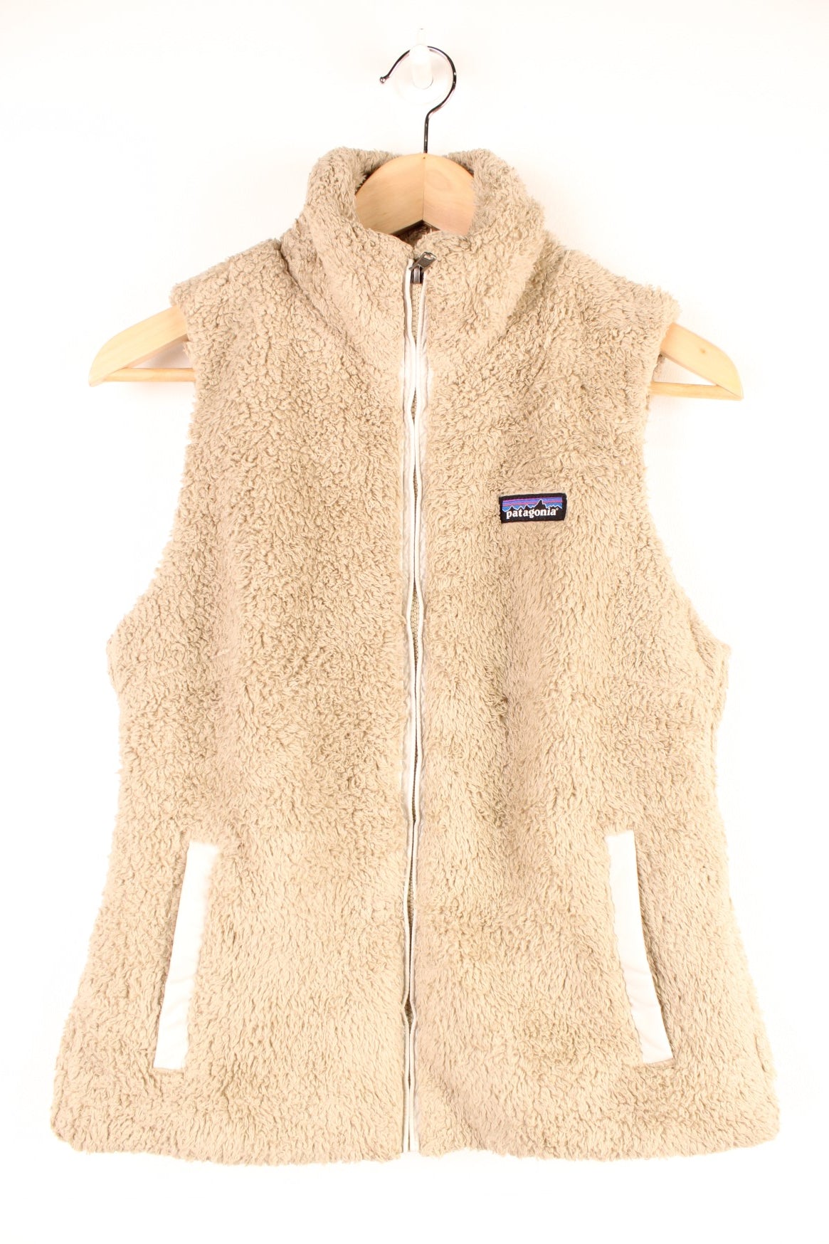 Tan Patagonia fluffy fleece gilet with zip closure, two zipped pockets and an embroidered logo on the chest. 