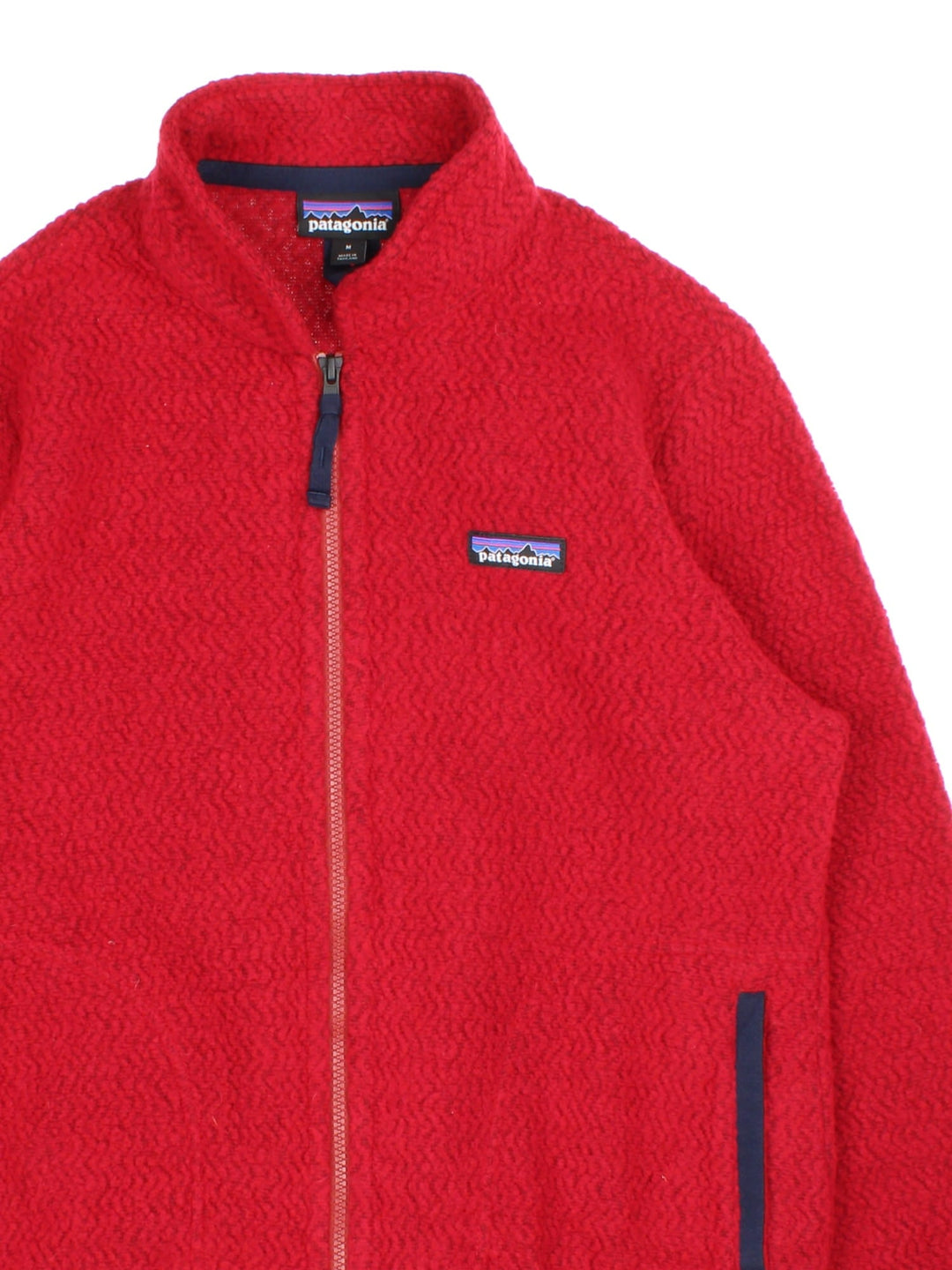 Patagonia Woolyester Fleece in a red colourway with a black trim, Full zip with side pockets and has small classic logo embroidered on the front.