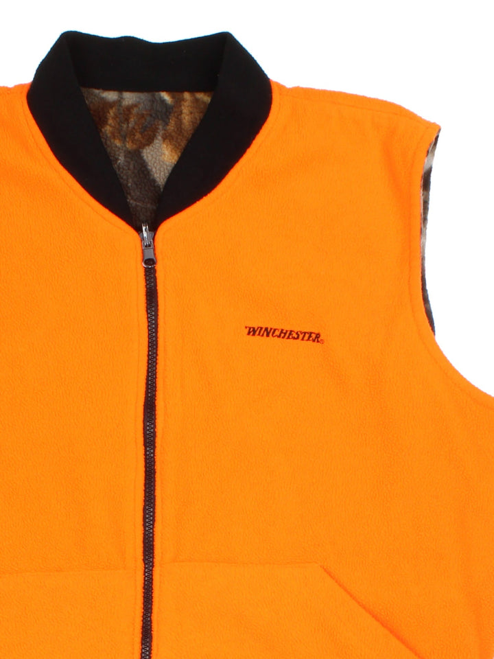 Vintage Winchester Reversable Fleece Gilet in a brown colourway. Camo print with orange reversable side, Full zip with two front pockets. Small logo on chest.