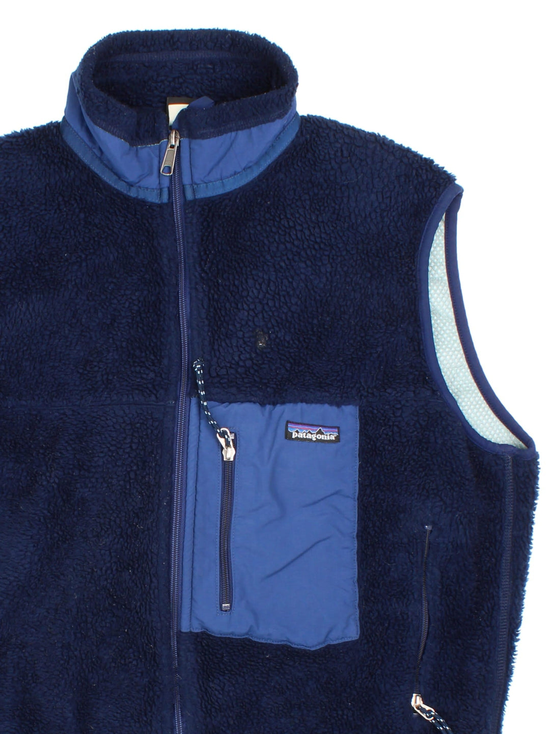 Patagonia Fleece Gilet in a blue colourway. Full zip with multiple zip pockets and small classic logo on the front.