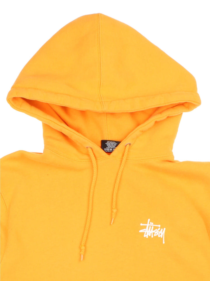 Stussy Hoodie in a yellow colourway with classic small logo on the front and large logo graphic on the back.