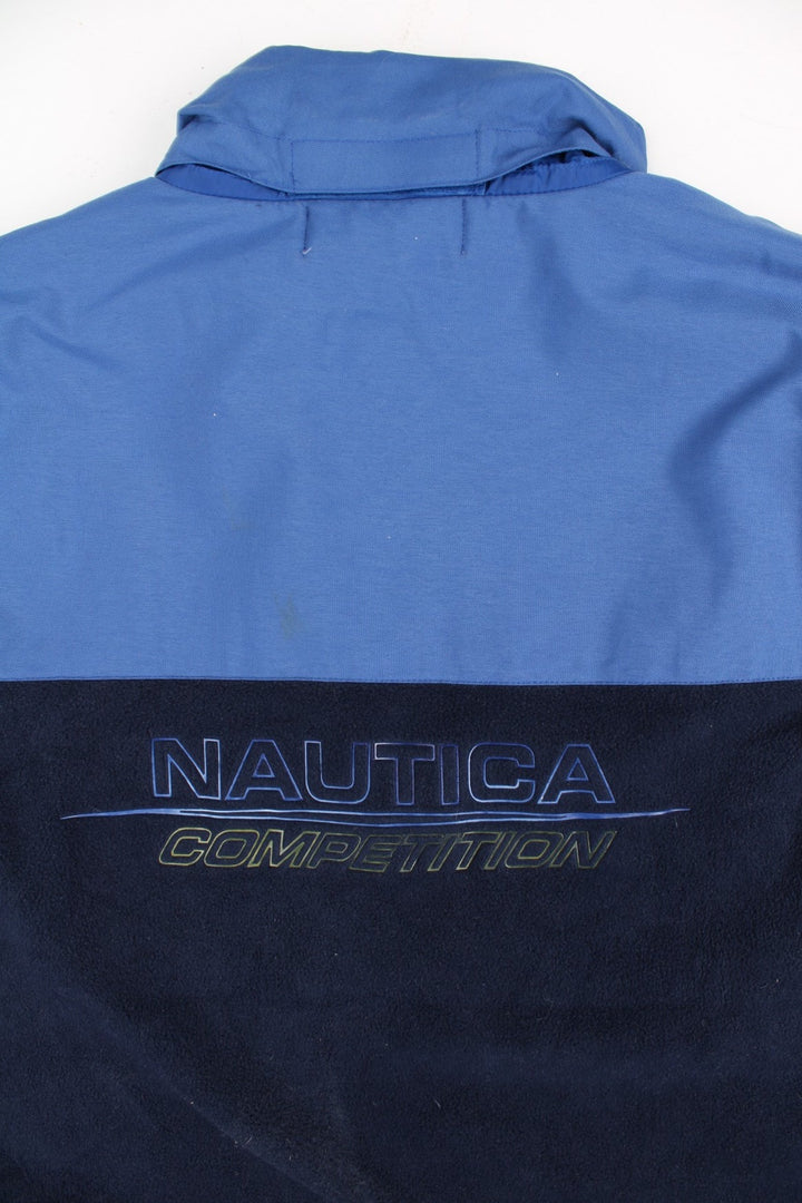 Nautica Competition Fleece Vest in a blue colourway. Zips up and a front chest pocket, hidden hood, and has the logo embroidered on the front and back.