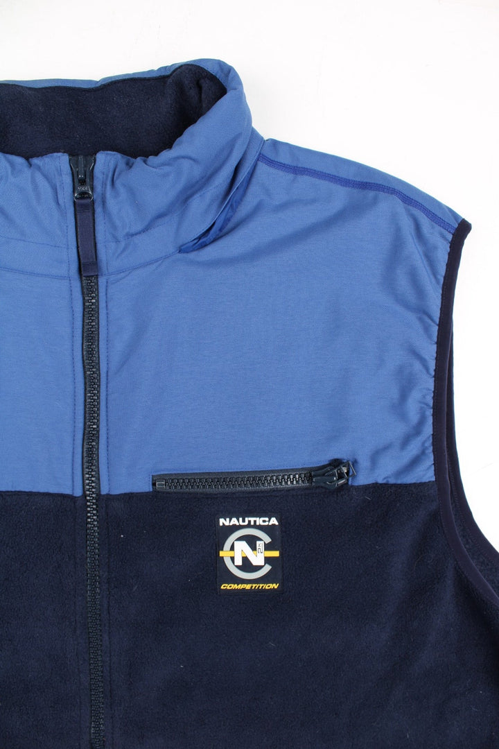 Nautica Competition Fleece Vest in a blue colourway. Zips up and a front chest pocket, hidden hood, and has the logo embroidered on the front and back.