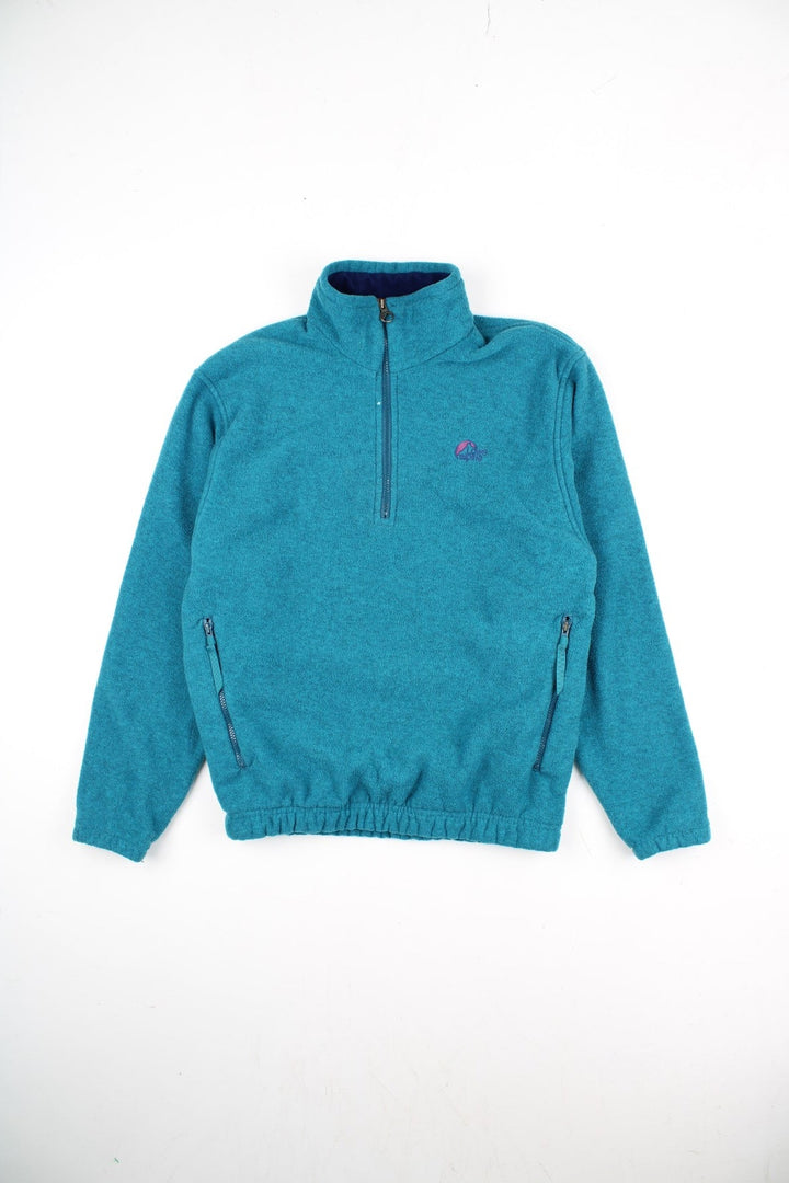 Vintage Lowe Alpine Pullover Fleece in a blue colourway. Half zip up and has side pockets, and the logo embroidered on the front.