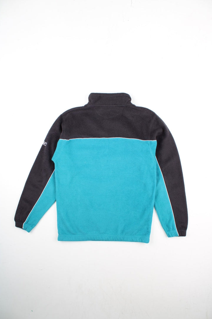 Vintage Reebok San Jose Sharks NHL Pullover Fleece in a blue and black colourway. 1/4 zip up and has pouch pocket, and the team logo embroidered on the front and Reebok logo on the left sleeve.