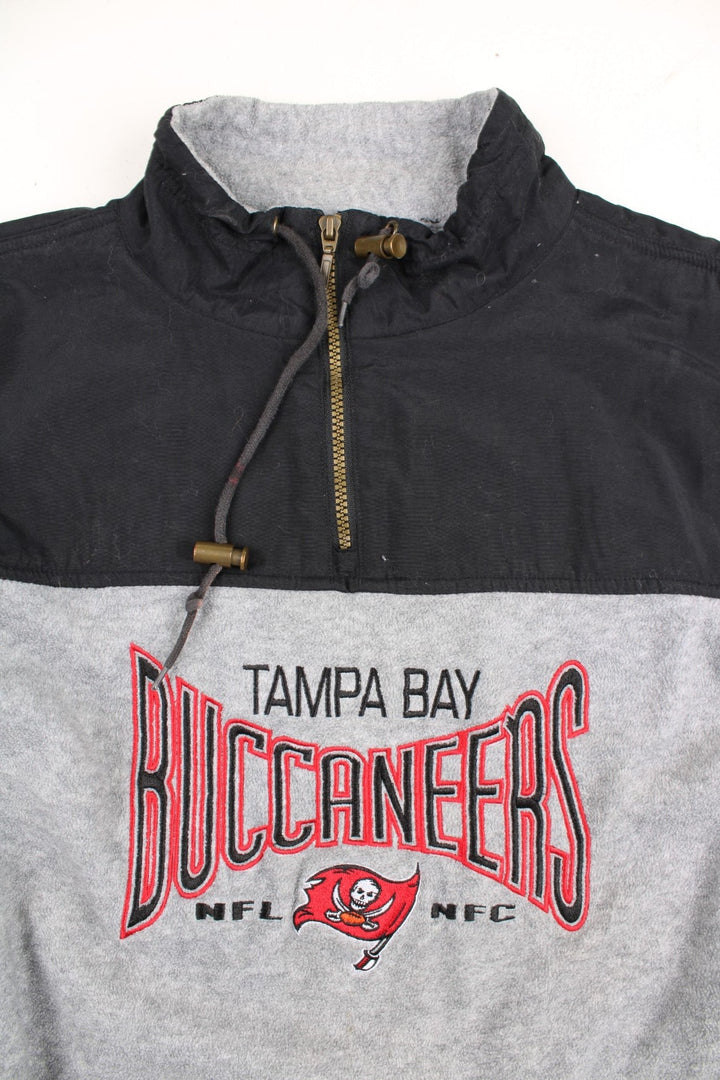 Vintage Lee Sport Tampa Bay Buccaneers NFL Fleece in a grey and black colourway. 1/4 zip up with drawstring collar, and has the logo embroidered on the front.