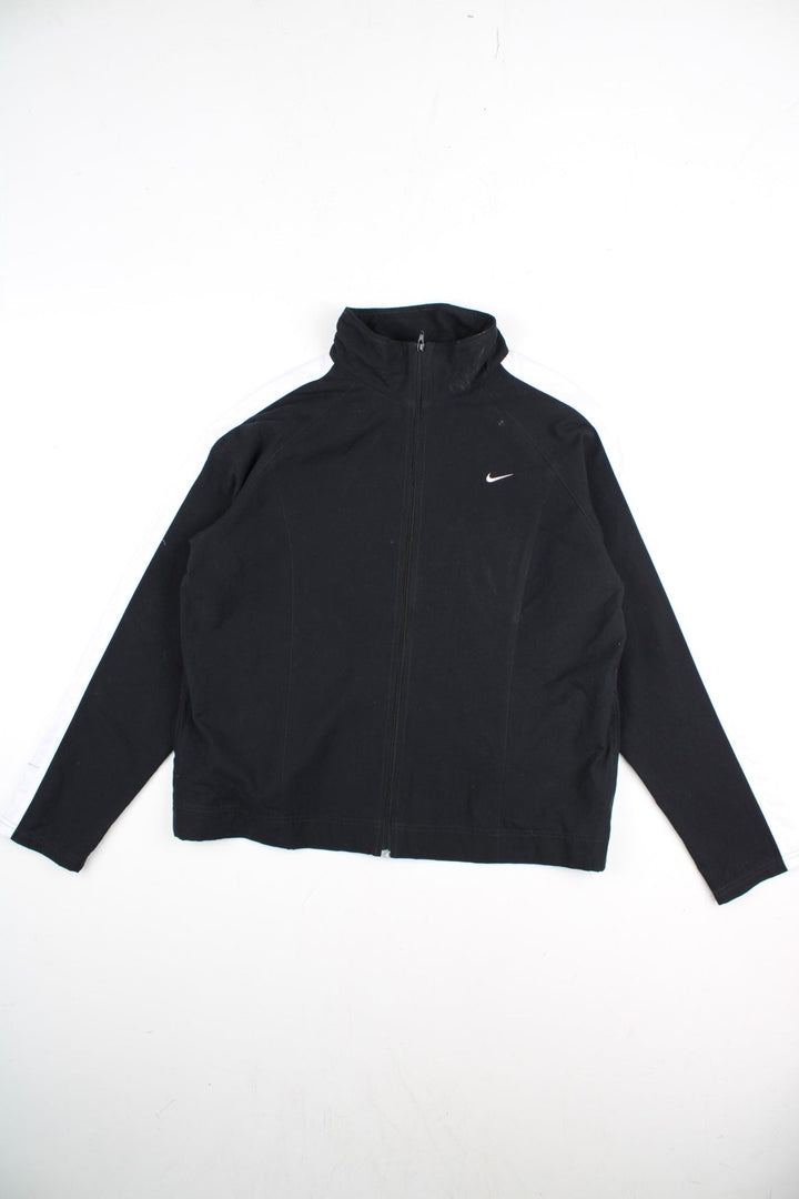 Vintage Nike Tracksuit Jacket in a black and white colourway. Zips up and has side pockets, and the logo embroidered on the front.