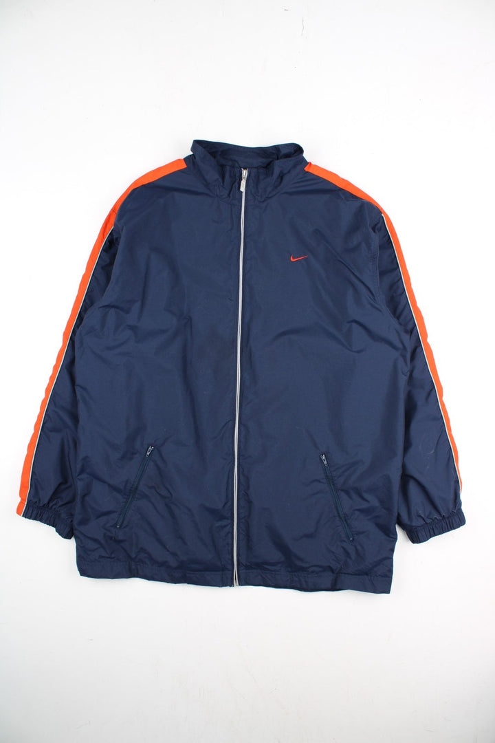 Vintage Y2K Nike Windbreaker Jacket in a blue and orange colourway. Zips up and has side pockets, and the logo embroidered on the front and back.