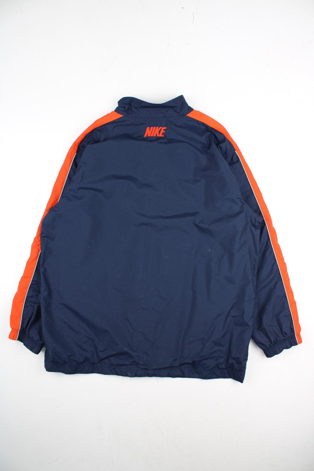 Vintage Y2K Nike Windbreaker Jacket in a blue and orange colourway. Zips up and has side pockets, and the logo embroidered on the front and back.