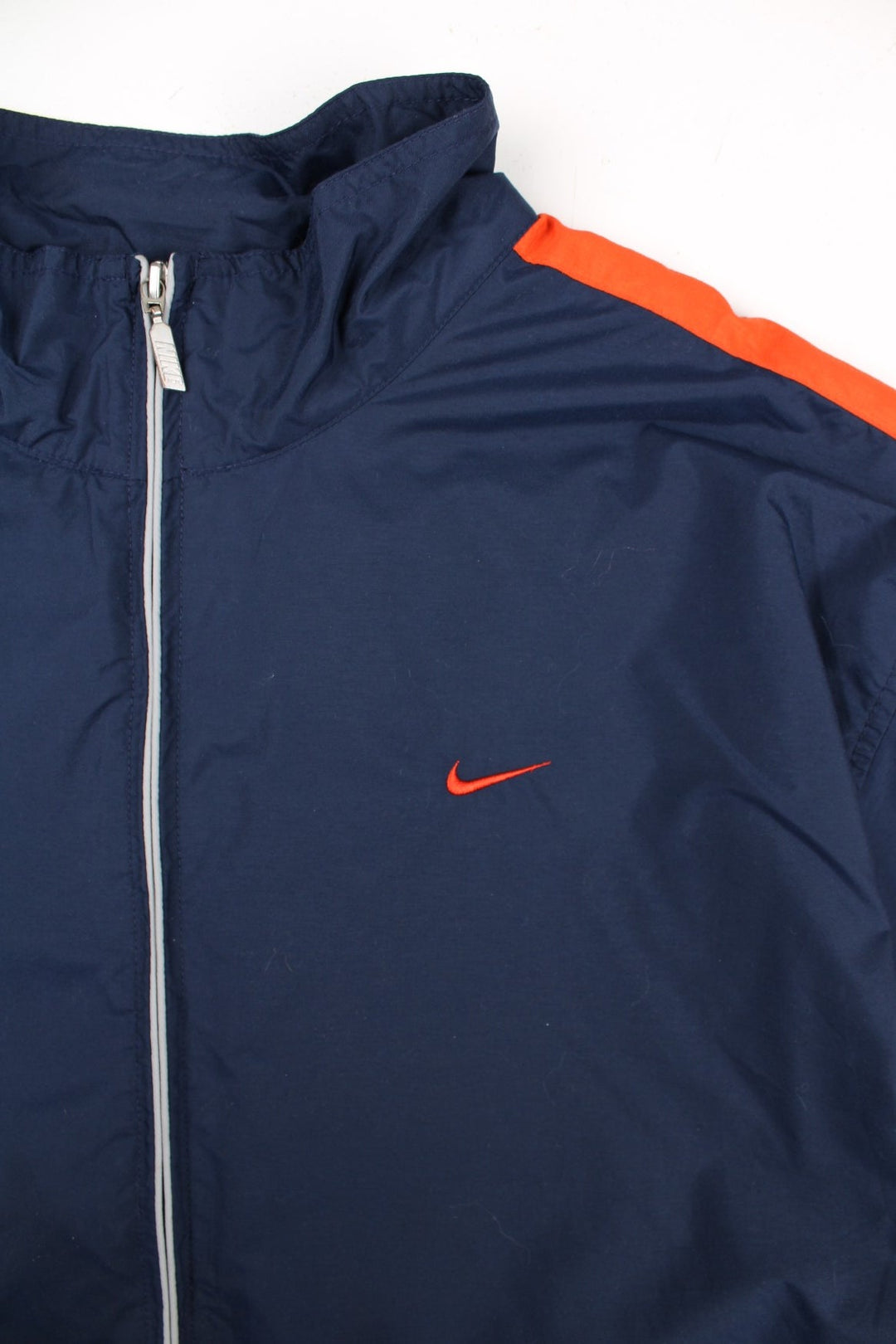 Vintage Y2K Nike Windbreaker Jacket in a blue and orange colourway. Zips up and has side pockets, and the logo embroidered on the front and back.