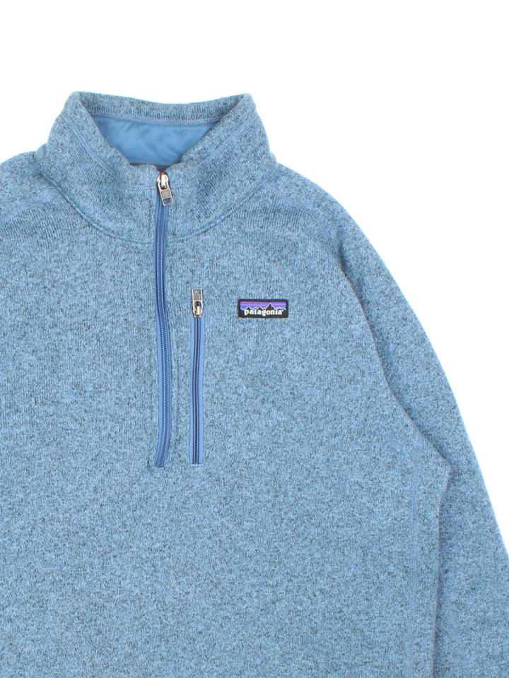 Patagonia Fleece Jacket in a blue colourway. 1/4 zip up and has a small pocket on front, Small classic logo also on front left.