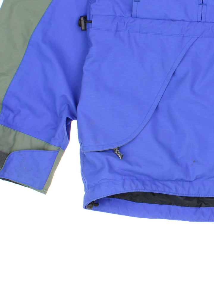 Vintage Rab Heavy Jacket in a blue colourway. Multiple pockets with zips and drawstring at the hip, Green panelling down shoulders and arms.