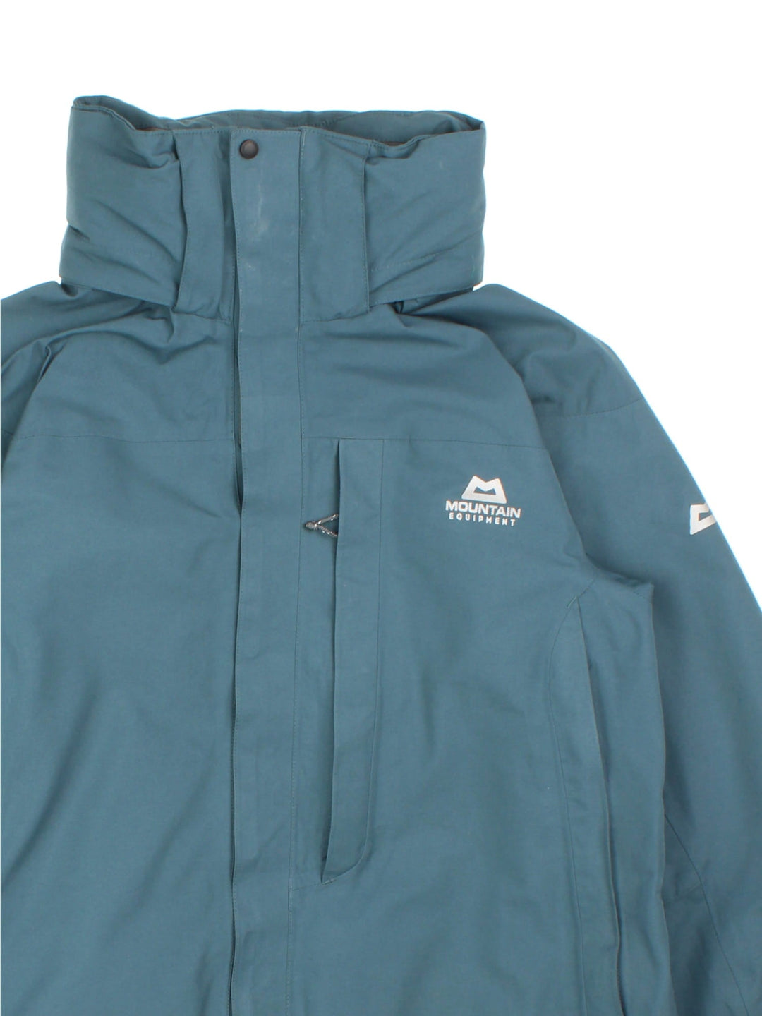 Mountain Equipment Coat in a green colourway. Multiple zip pockets, Gore-tex technology, fold away hood and drawstring hem. Small logo on front and sleeve.