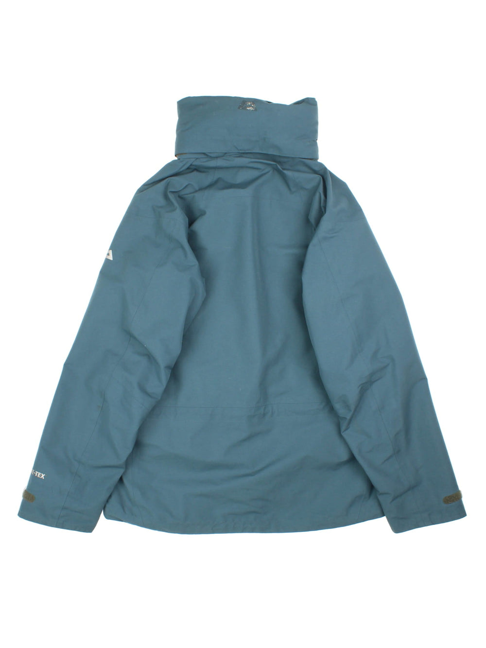 Mountain Equipment Coat in a green colourway. Multiple zip pockets, Gore-tex technology, fold away hood and drawstring hem. Small logo on front and sleeve.