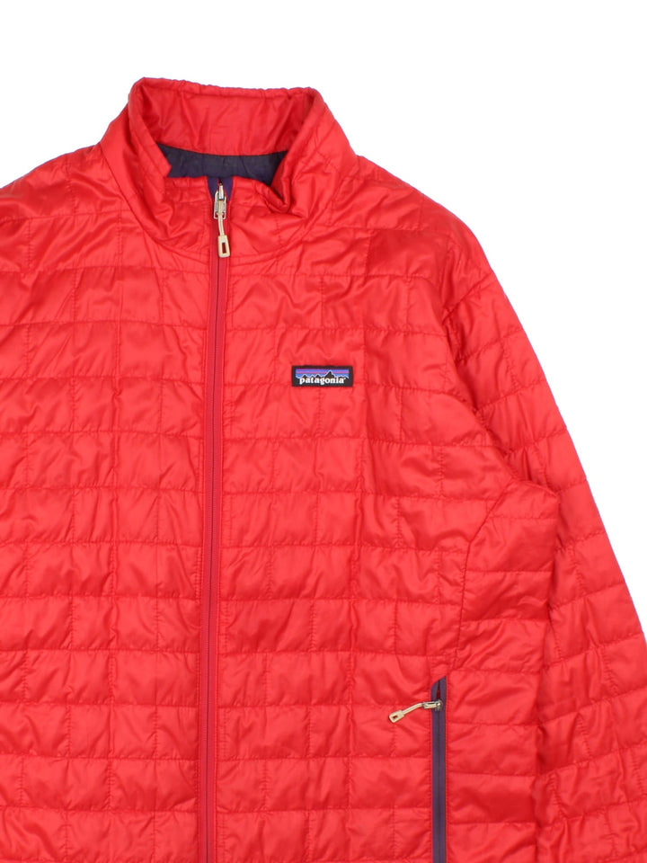 Vintage Patagonia Puffer Jacket in a red colourway. Full zip with two side pockets on the front, small classic logo also embroidered on the chest.