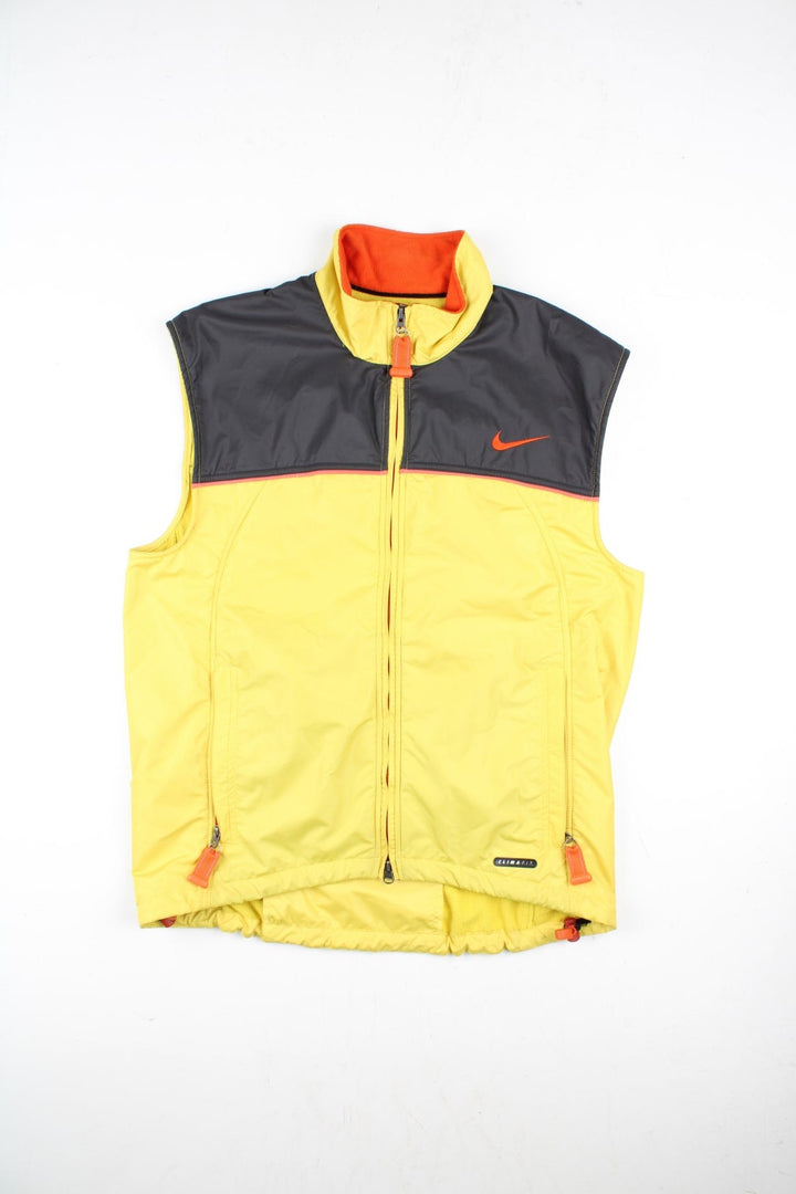 Vintage Nike ACG Gilet in a yellow/black colourway. Zip up with side/back zip pockets and fleece lining, and has the logo embroidered on the front and back.