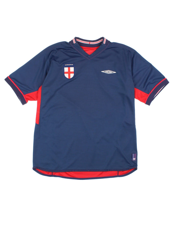 England 2002/04 Umbro Reversible Football Shirt in either a red or blue away kit colourway options, features embroidered logos and badge on the front.