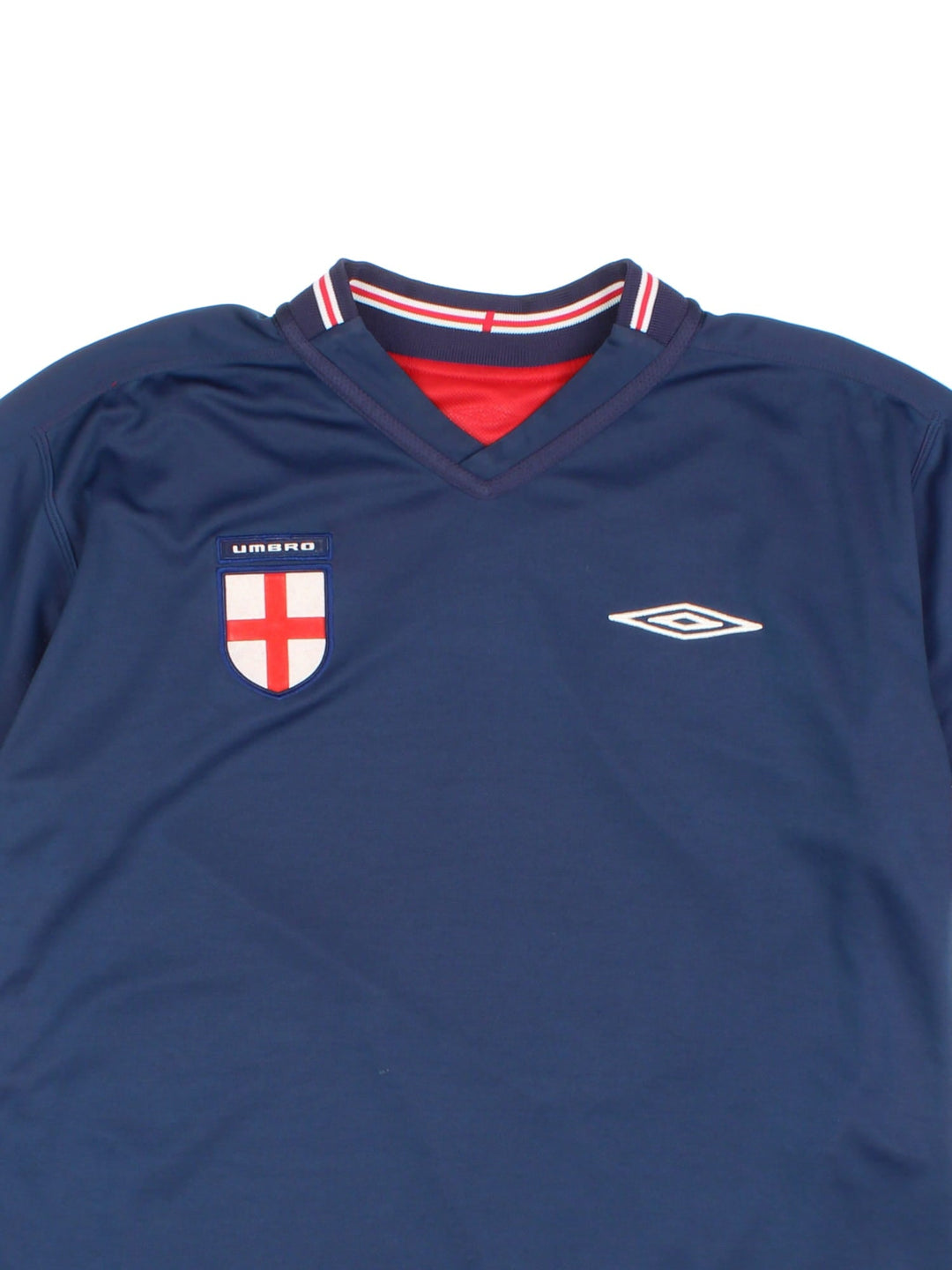 England 2002/04 Umbro Reversible Football Shirt in either a red or blue away kit colourway options, features embroidered logos and badge on the front.