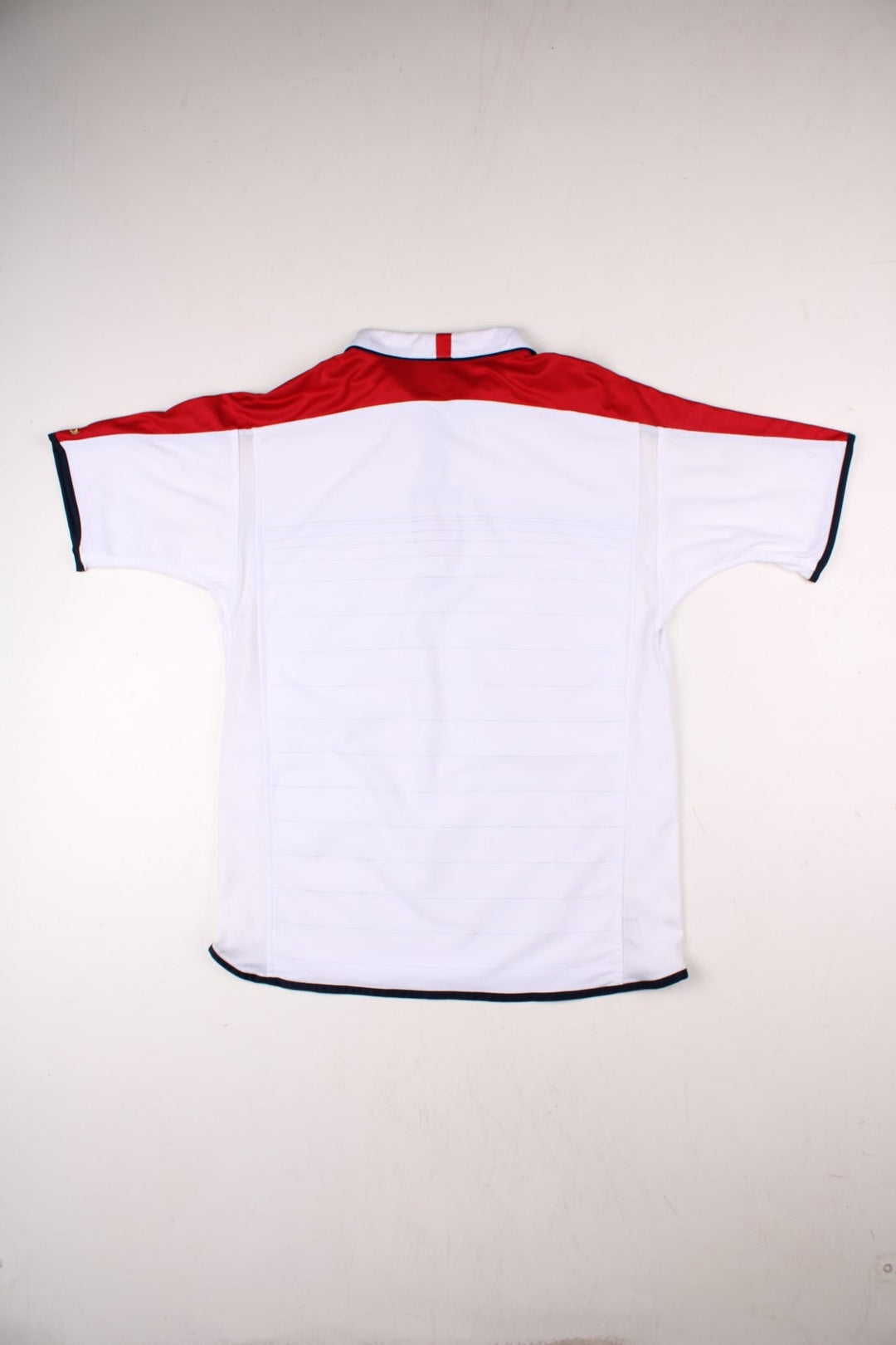 England 2004/06 Umbro Football Shirt in the white home kit colourway, features embroidered logos and badge on the front with reversible option.