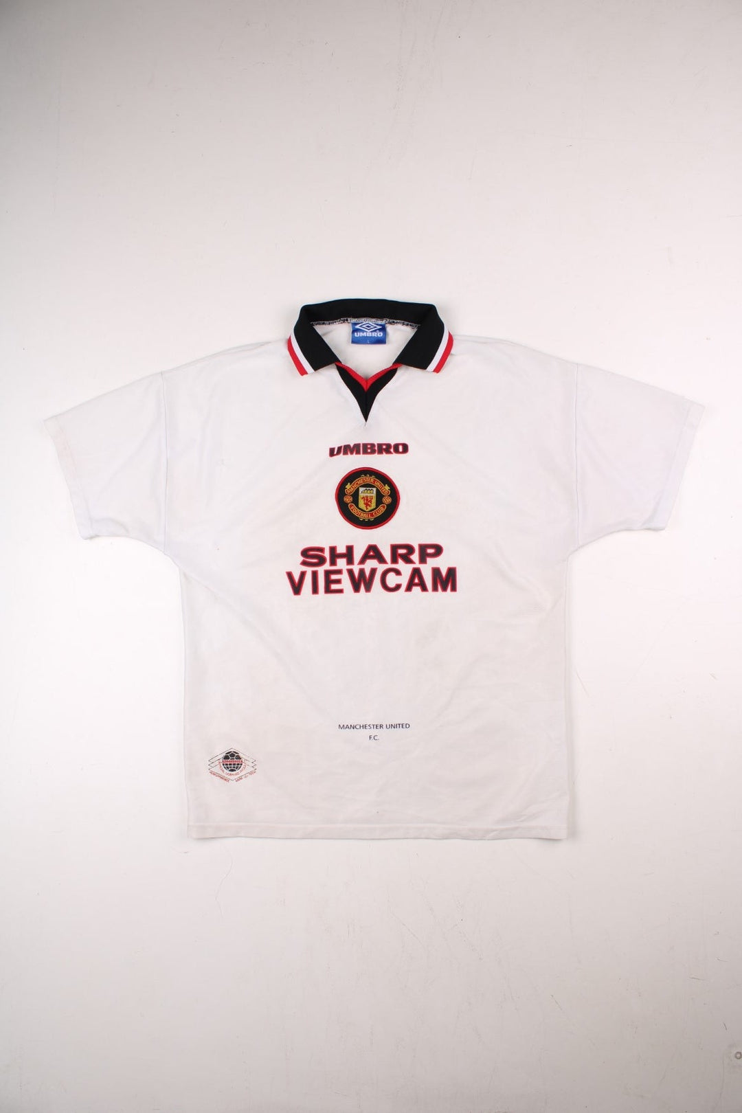 Manchester United 1996/97 Umbro Football Shirt in the white away kit colourway, features embroidered logos and badge on the front.