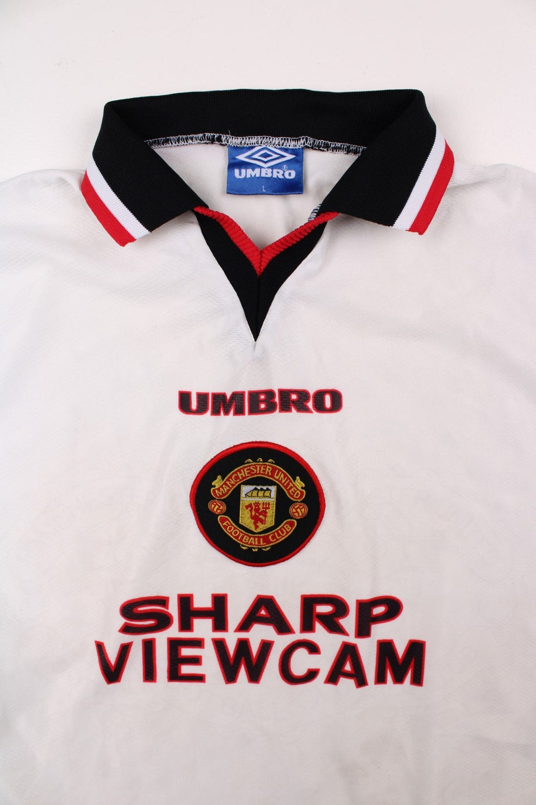 Manchester United 1996/97 Umbro Football Shirt in the white away kit colourway, features embroidered logos and badge on the front.