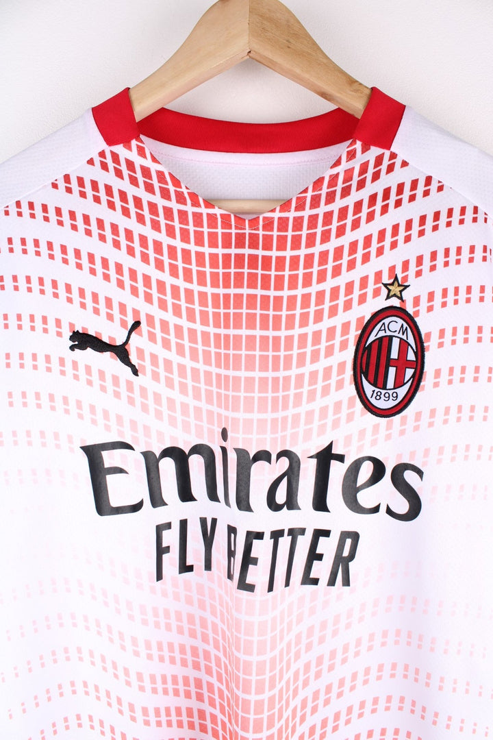 AC Milan 2020/21 Puma Away Football Shirt in the a white and red colourway, features embroidered logos and badge on the front.