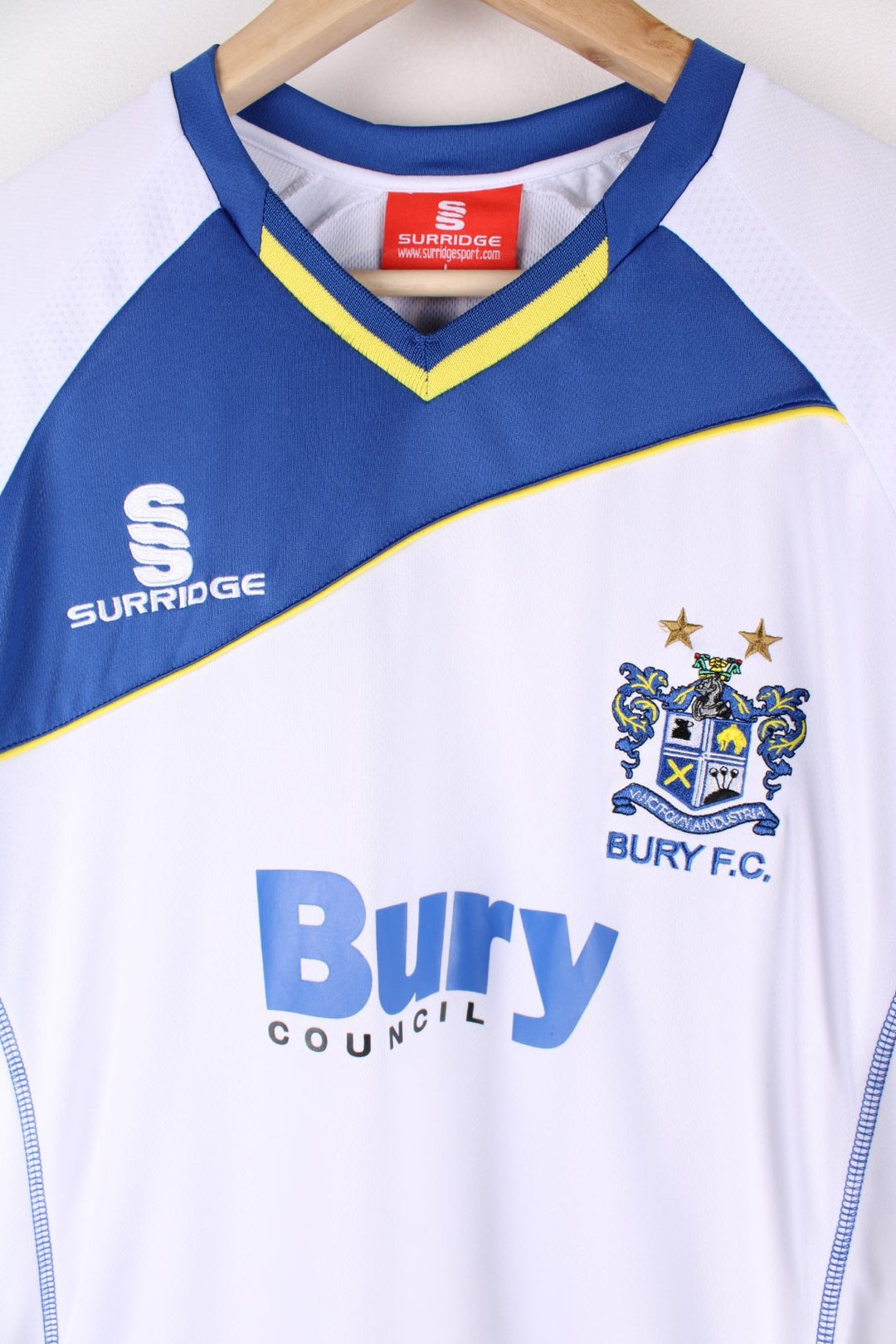 Vintage Bury FC 2012/13 Football Shirt in the white and blue home kit colourway, features embroidered logo and badge on the front, and on the back has Morley number 40 printed alongside team signatures.