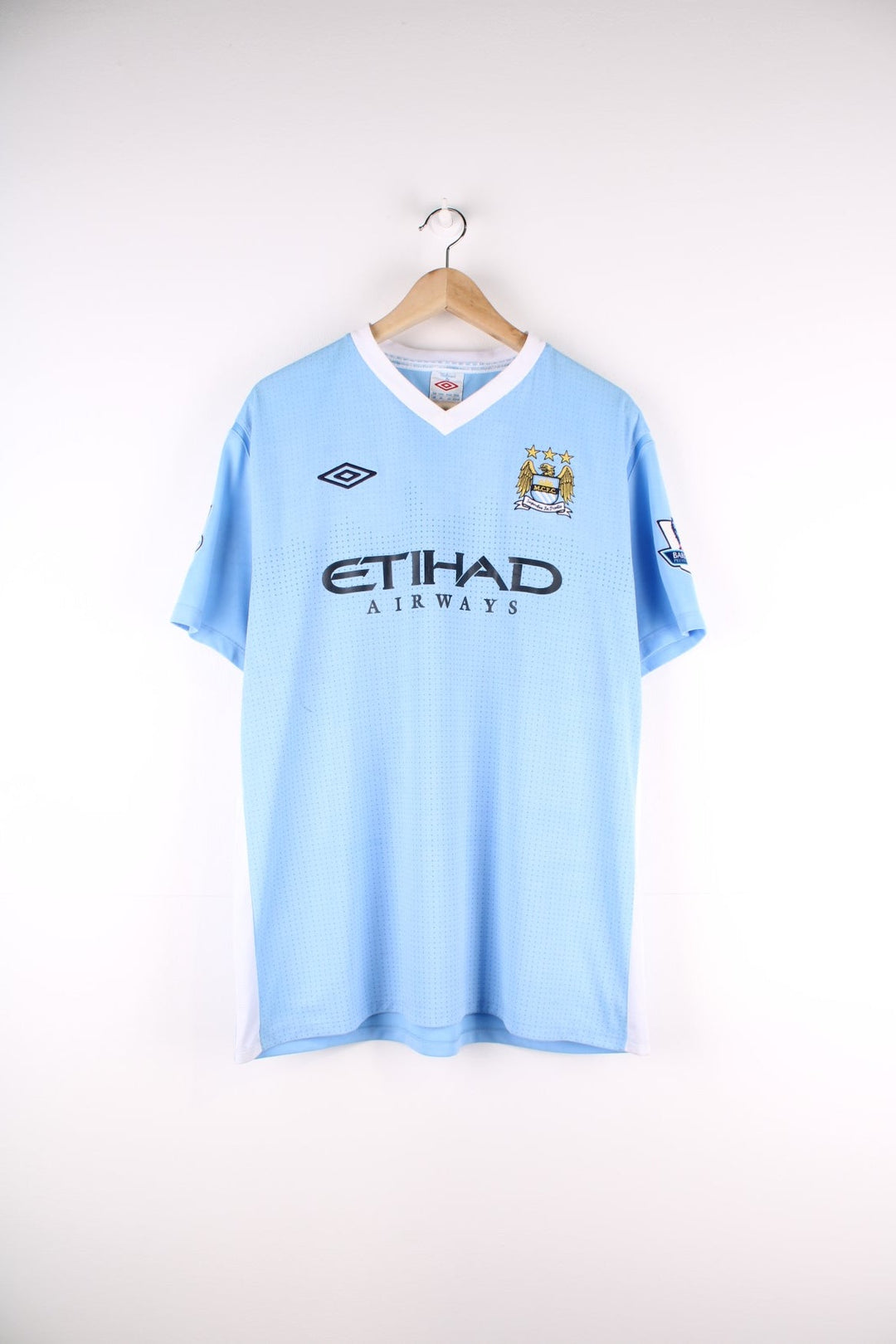 Manchester City 2011/12 Umbro Football Shirt in the blue home kit colourway, features embroidered logos and badge on the front.