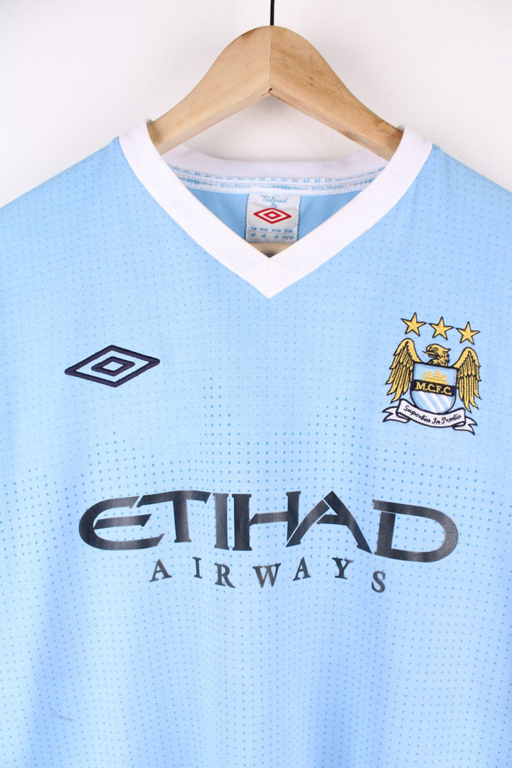 Manchester City 2011/12 Umbro Football Shirt in the blue home kit colourway, features embroidered logos and badge on the front.