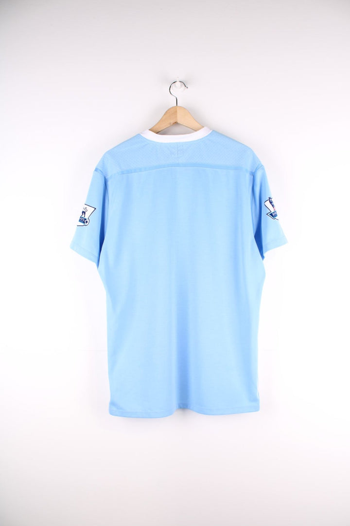 Manchester City 2011/12 Umbro Football Shirt in the blue home kit colourway, features embroidered logos and badge on the front.