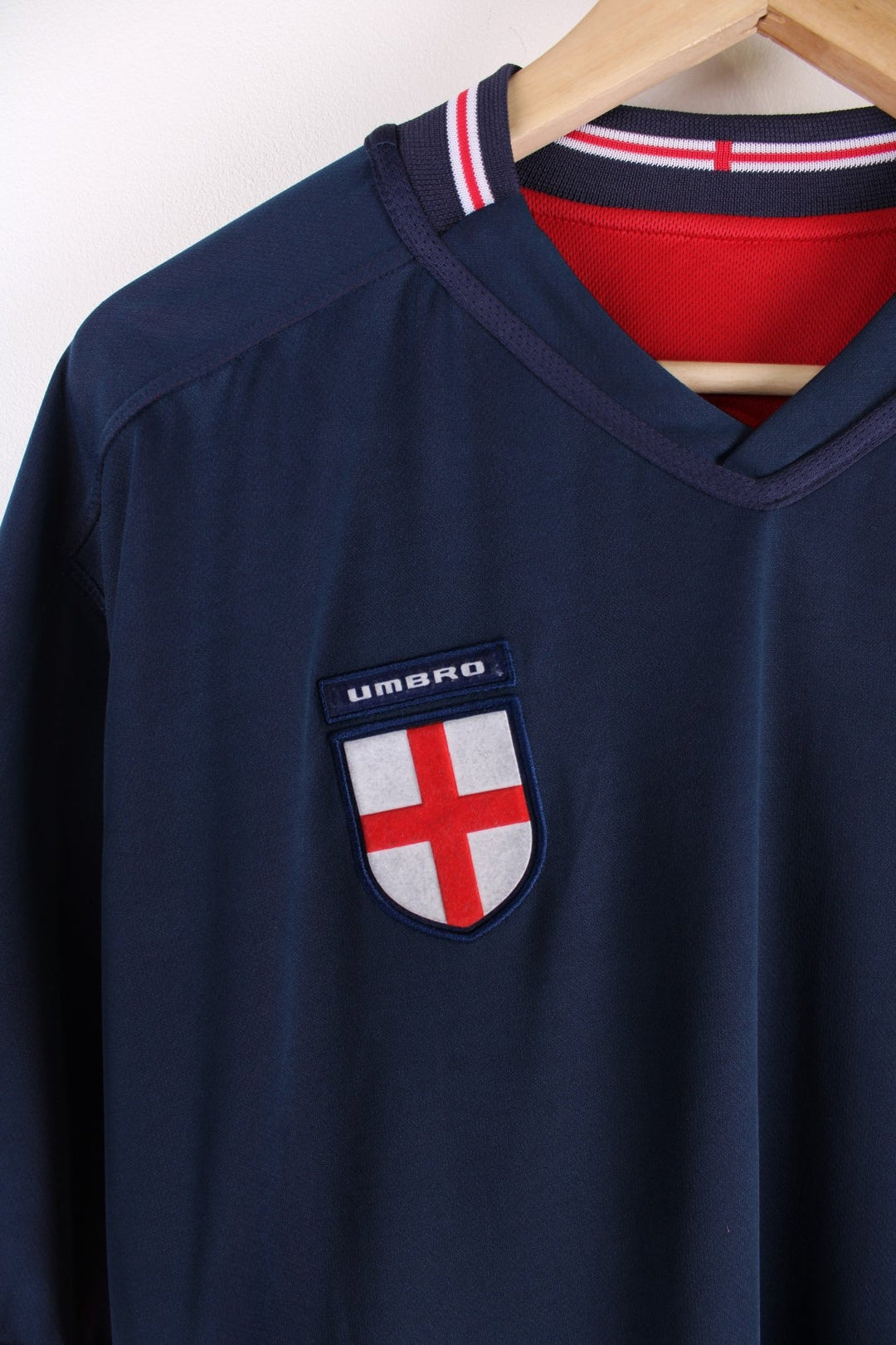 England 2002/04 Reversible Umbro Football Shirt in either a red or blue away kit colourway options, features embroidered logo and badge on the front.