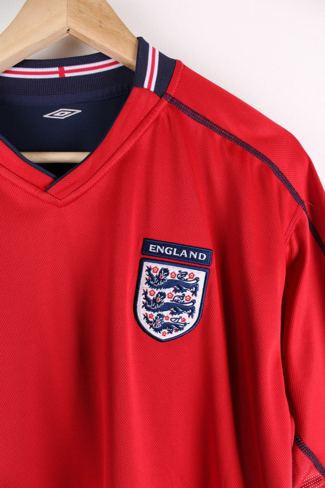 England 2002/04 Reversible Umbro Football Shirt in either a red or blue away kit colourway options, features embroidered logo and badge on the front.