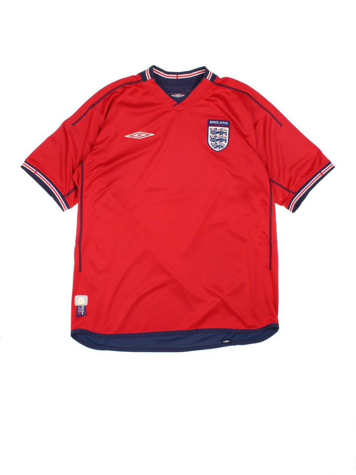 England 2002/04 Umbro Reversible Football Shirt in either a red or blue away kit colourway options, features embroidered logos and badge on the front.