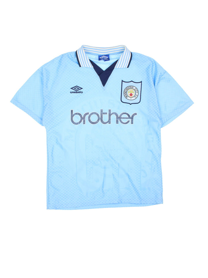 Manchester City 1995/97 Umbro Football Shirt in the blue home kit colourway, features embroidered logos and badge on the front.