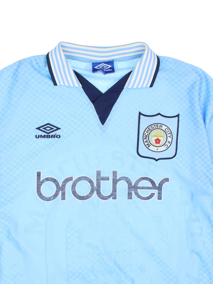 Manchester City 1995/97 Umbro Football Shirt in the blue home kit colourway, features embroidered logos and badge on the front.