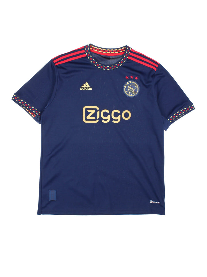 Ajax 2022/23 Adidas Football Shirt in the navy blue away kit colourway, features embroidered logos and badge on the front.