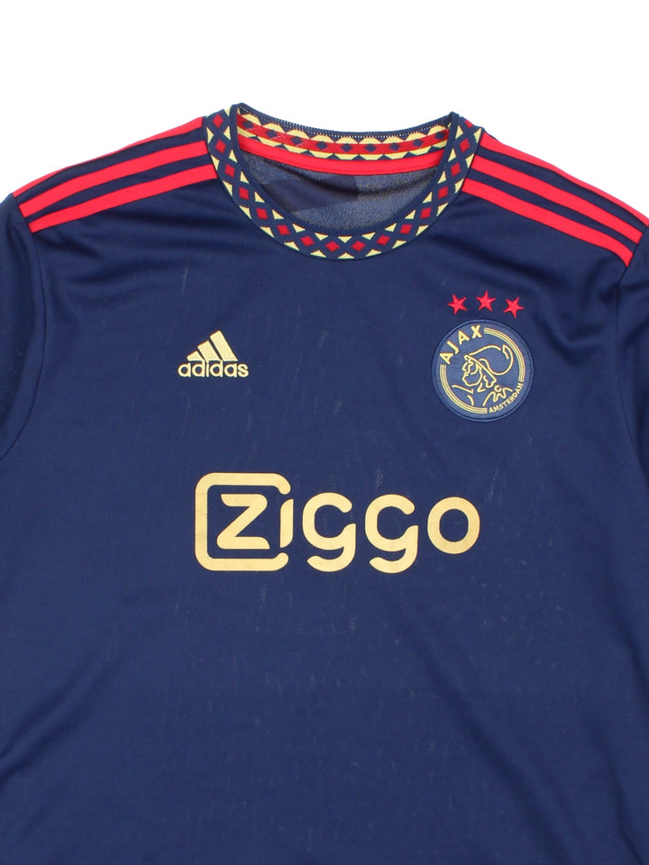 Ajax 2022/23 Adidas Football Shirt in the navy blue away kit colourway, features embroidered logos and badge on the front.