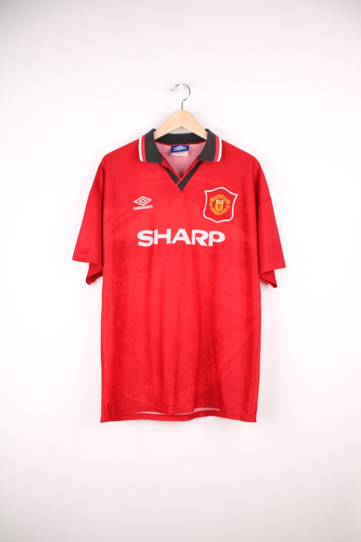 Manchester United 1994/95 Umbro Football Shirt in the red home colourway, features embroidered logo and badge on the front.