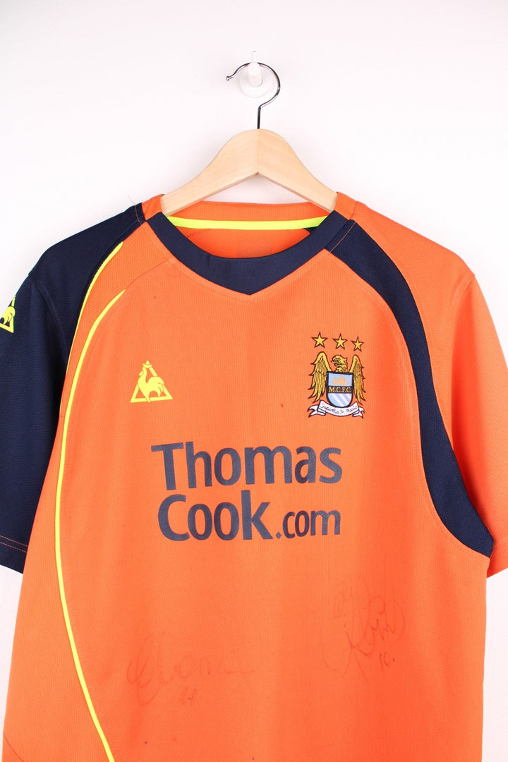 Manchester City 2008/09  Football Shirt in the  third kit colourway, features embroidered logo and badge on the front, and is signed by Elano number 11 and Robinho number 10.