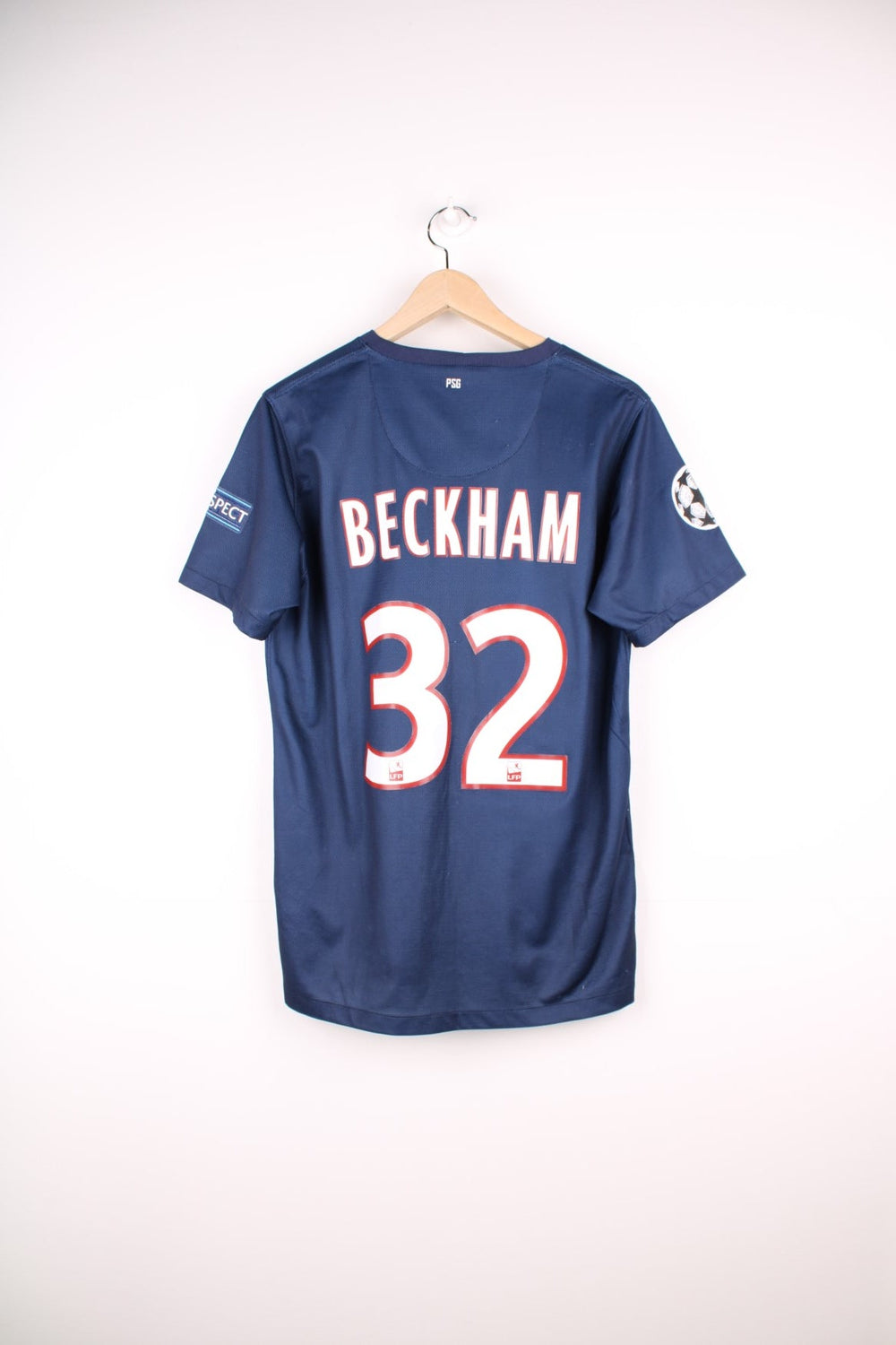 Paris Saint Germain 2012/13  Football Shirt in the  home kit colourway, features embroidered logo and badge on the front, and has David Beckham number 32 printed on the back.