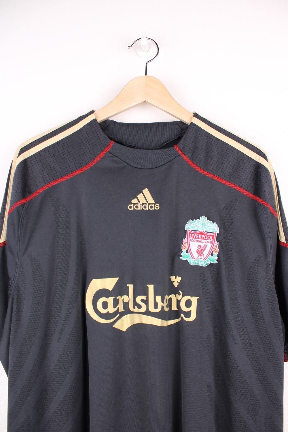 Liverpool 2009/10  Football Shirt in the  away kit colourway, features embroidered logo and badge on the front.