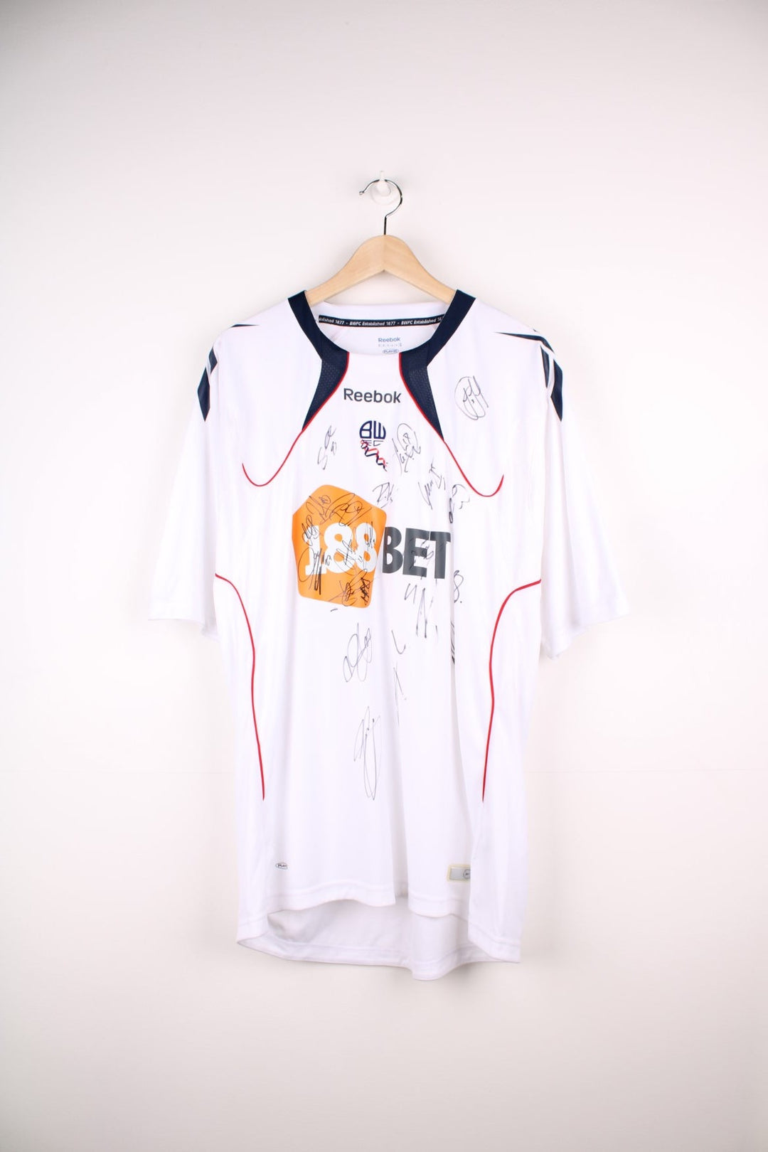 Bolton Wanderers 2010/11 Team Signed Reebok Football Shirt in the white home kit colourway, features embroidered logo and badge on the front, as well as signatures all over.