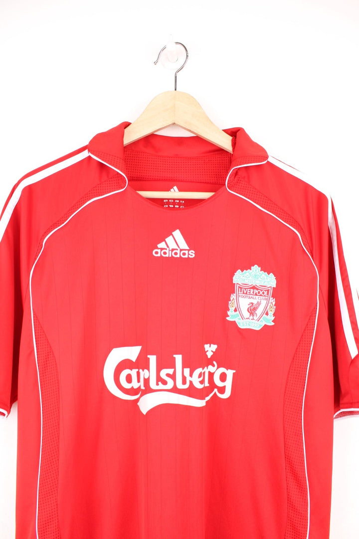 Liverpool 2006/07 Adidas Home Football Kit in the red and white team colourway, has Robbie Fowler number 9 printed on the back, and on the front the logos and sponsor. 