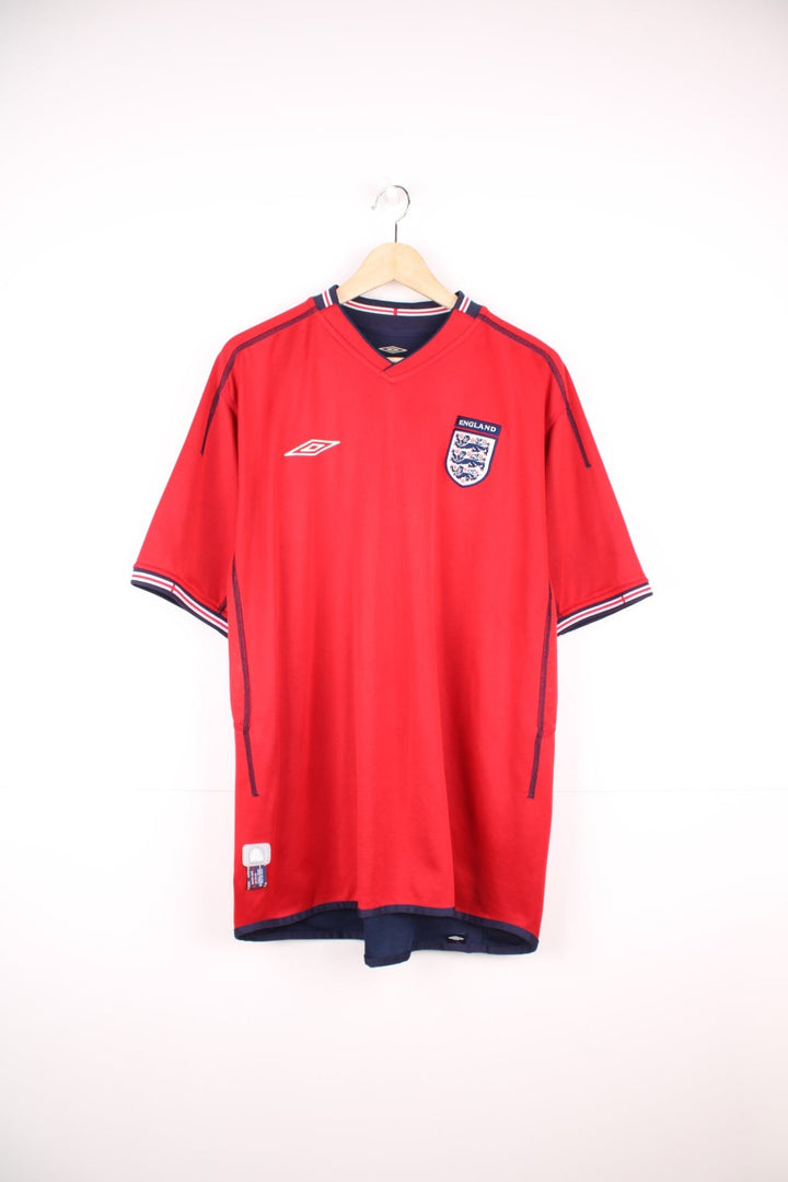 England 2002/04 Umbro Reversible Away Football Shirt in red and blue. Features embroidered logo and badge. 