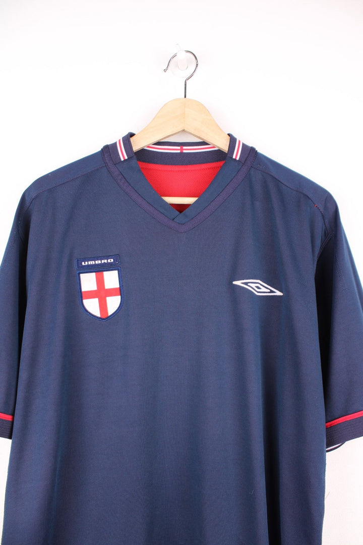 England 2002/04 Umbro Reversible Away Football Shirt in red and blue. Features embroidered logo and badge. 