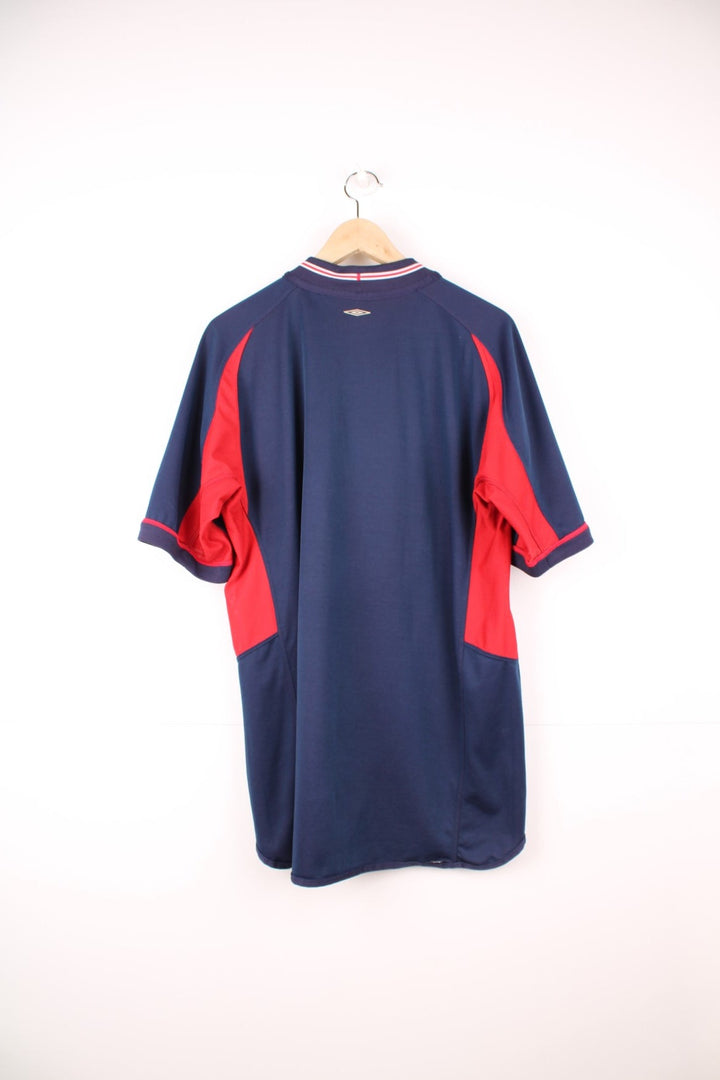 England 2002/04 Umbro Reversible Away Football Shirt in red and blue. Features embroidered logo and badge. 