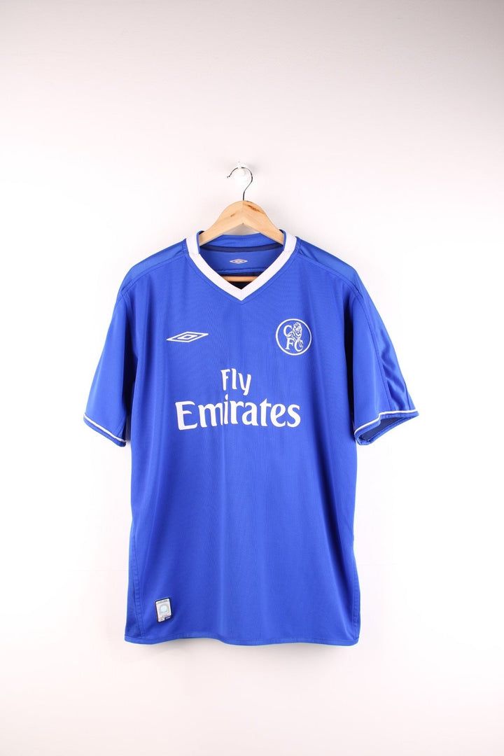 Chelsea 2003/05 Umbro Football Shirt in the blue home kit colourway, v neck and features embroidered logos and badge on the front.