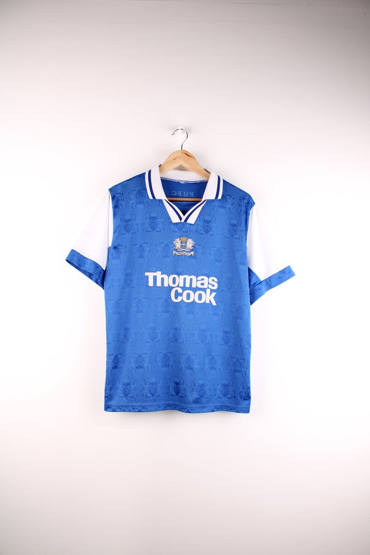 Vintage Peterborough United 1995/96 Home Football Shirt in the blue and white team colourway, features embroidered logos and badge on the front and the number 14 printed on the back.