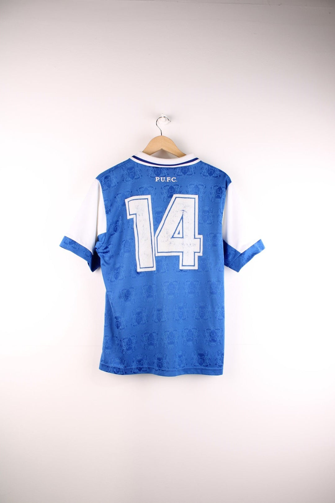  Peterborough United 1995/96 Home Football Shirt in the  and white team colourway, features embroidered logos and badge on the front and the number 14 printed on the back.