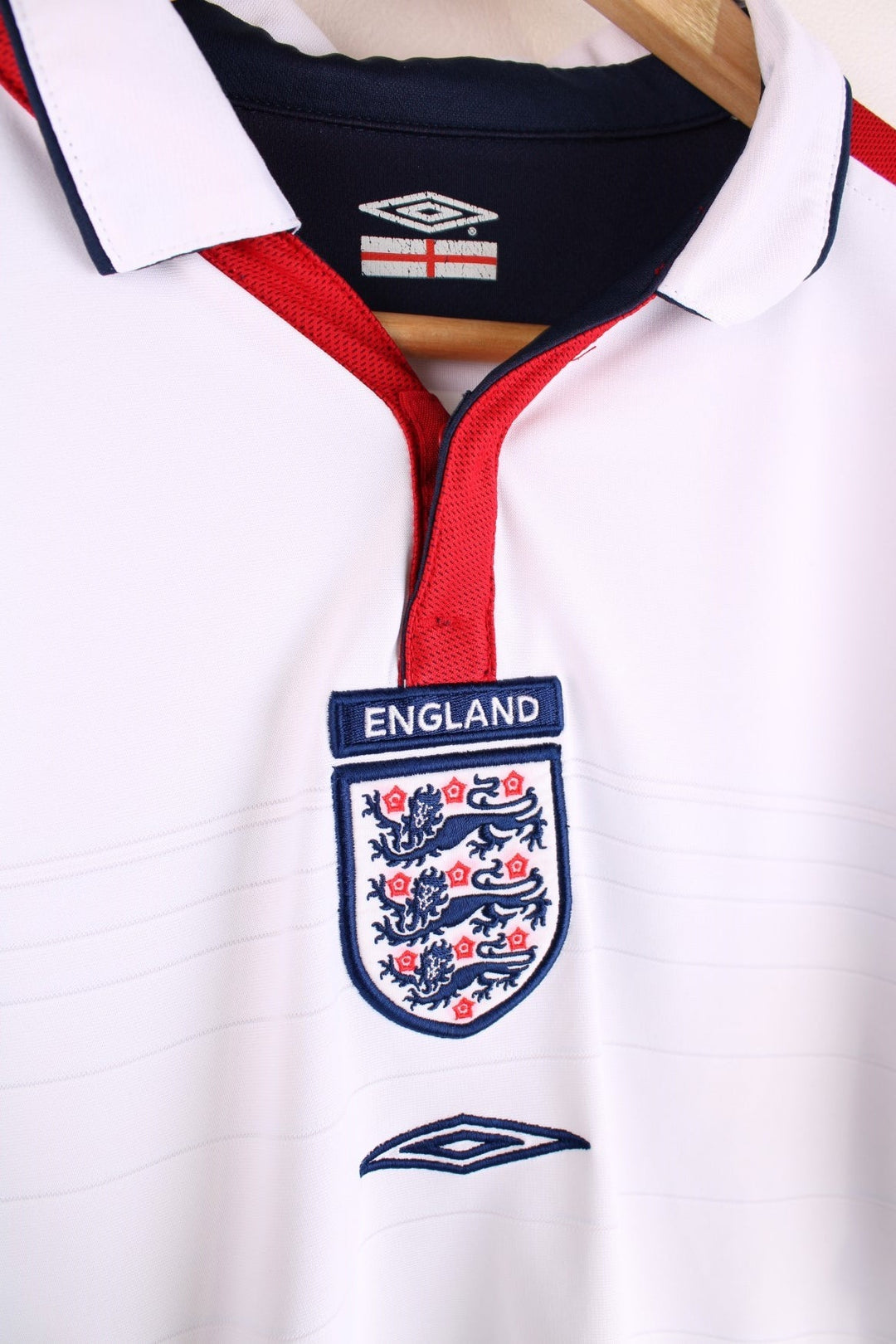 England 2003/05  Football Shirt in the  home kit colourway with reversible option, features embroidered logos and badge on the front.